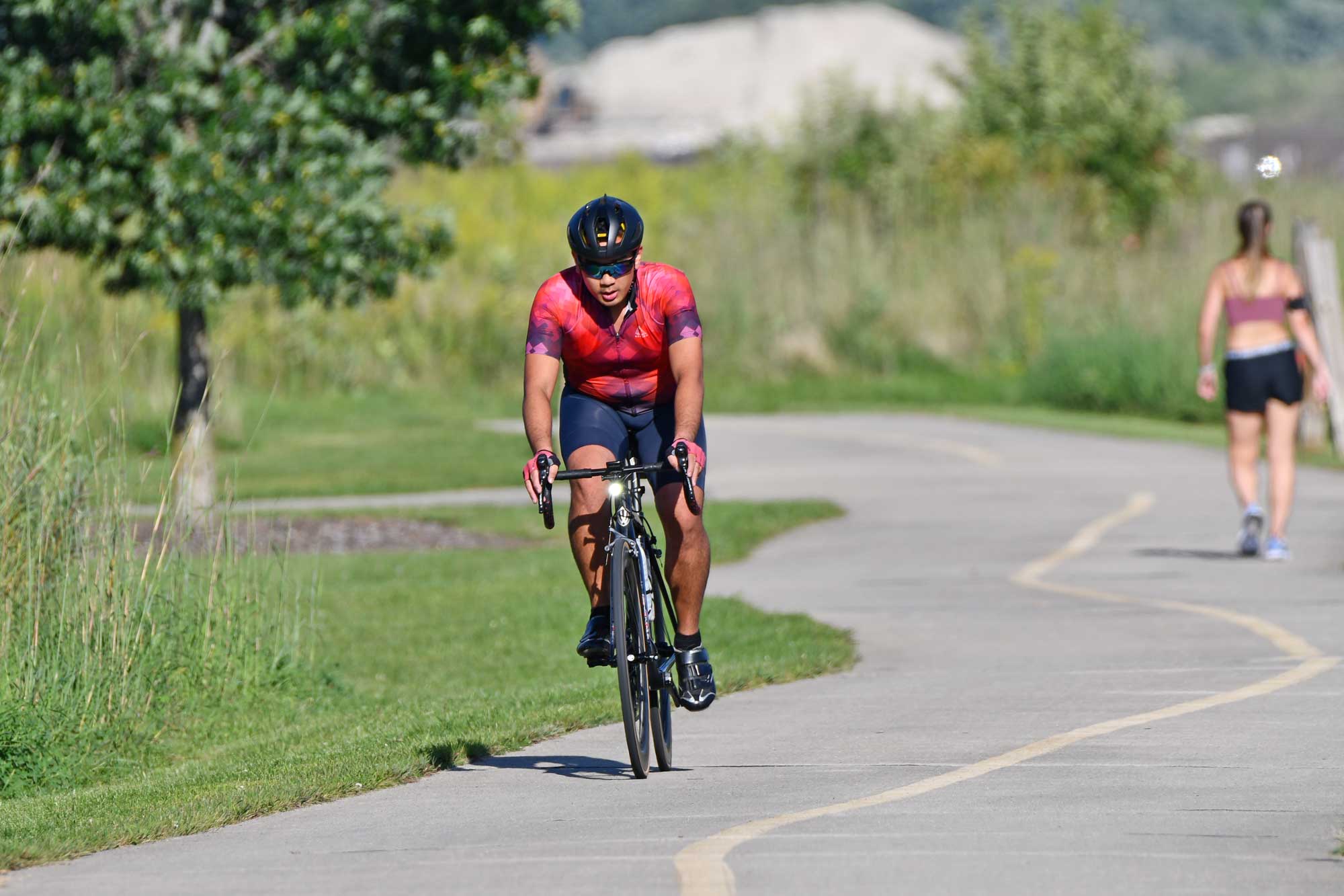 A man on a bicycle rides along a trail.
