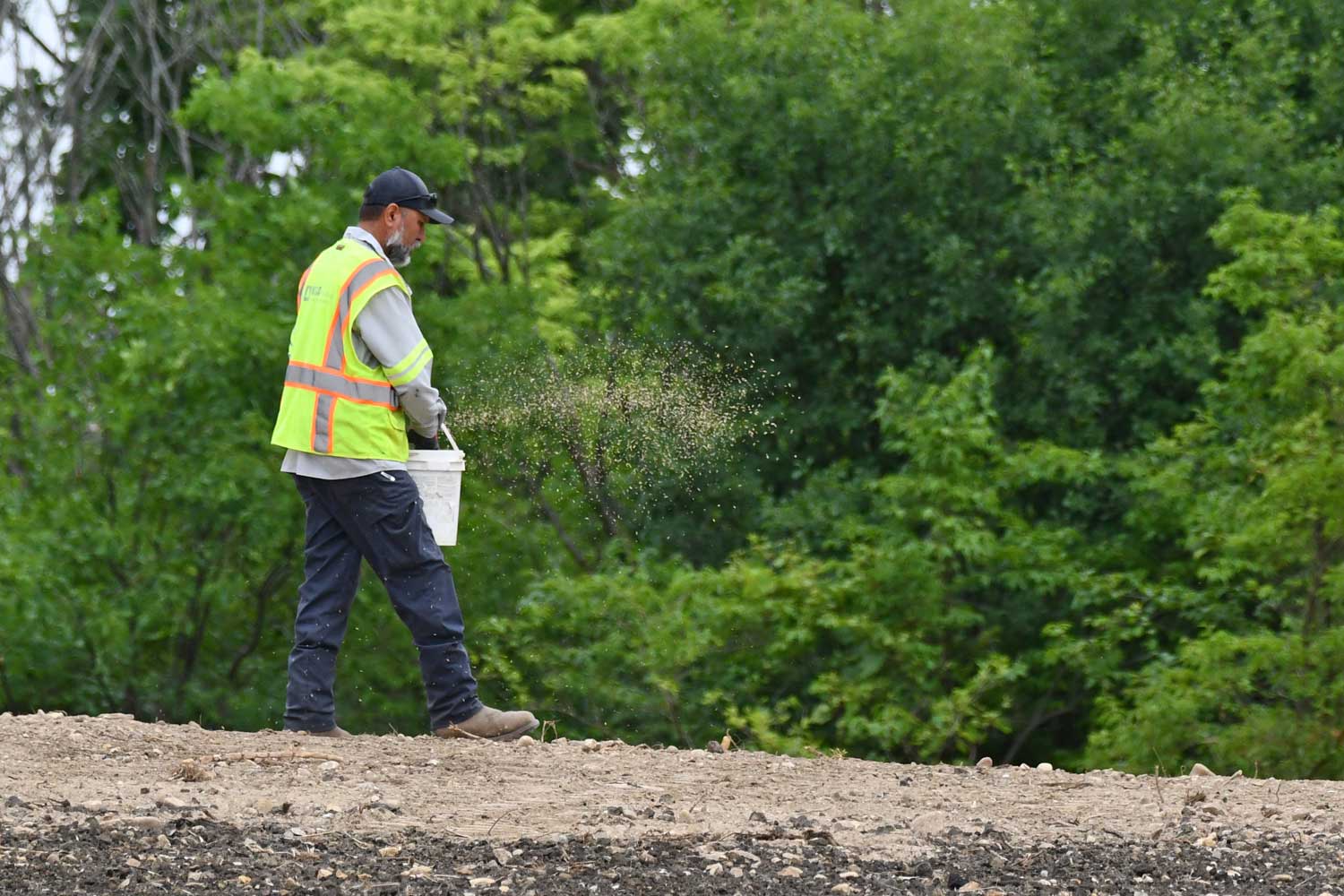 Construction worker laying materials.