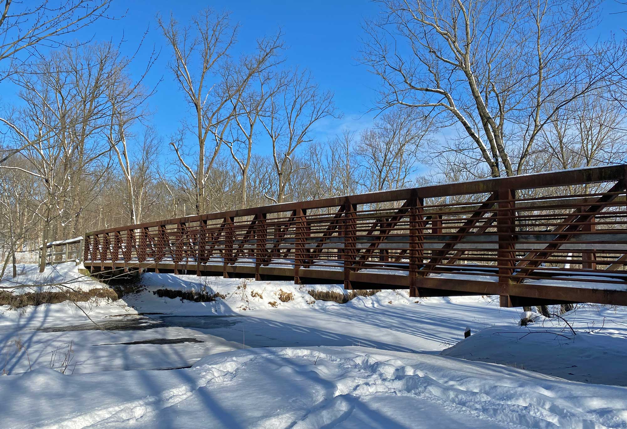 A view of a bridge over a frozen creek