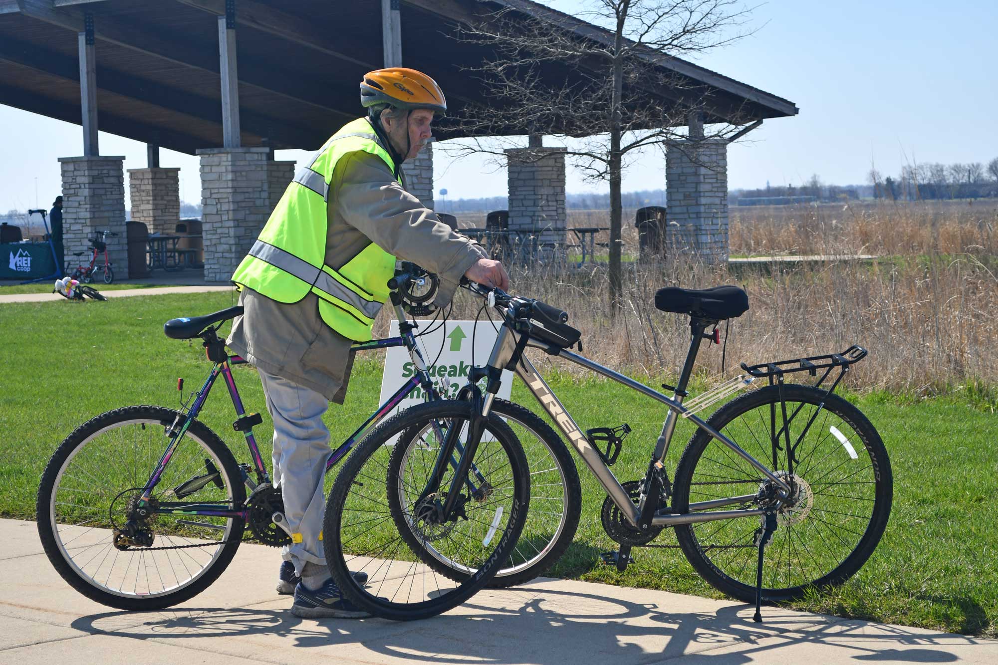 A man rides a bike in a forest preserve.
