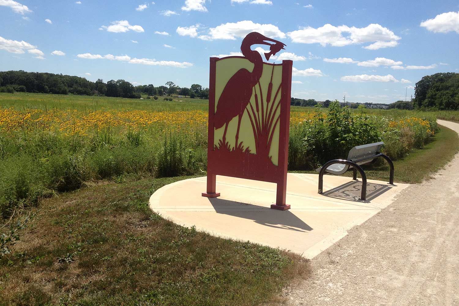 A sign and bench along the trail.