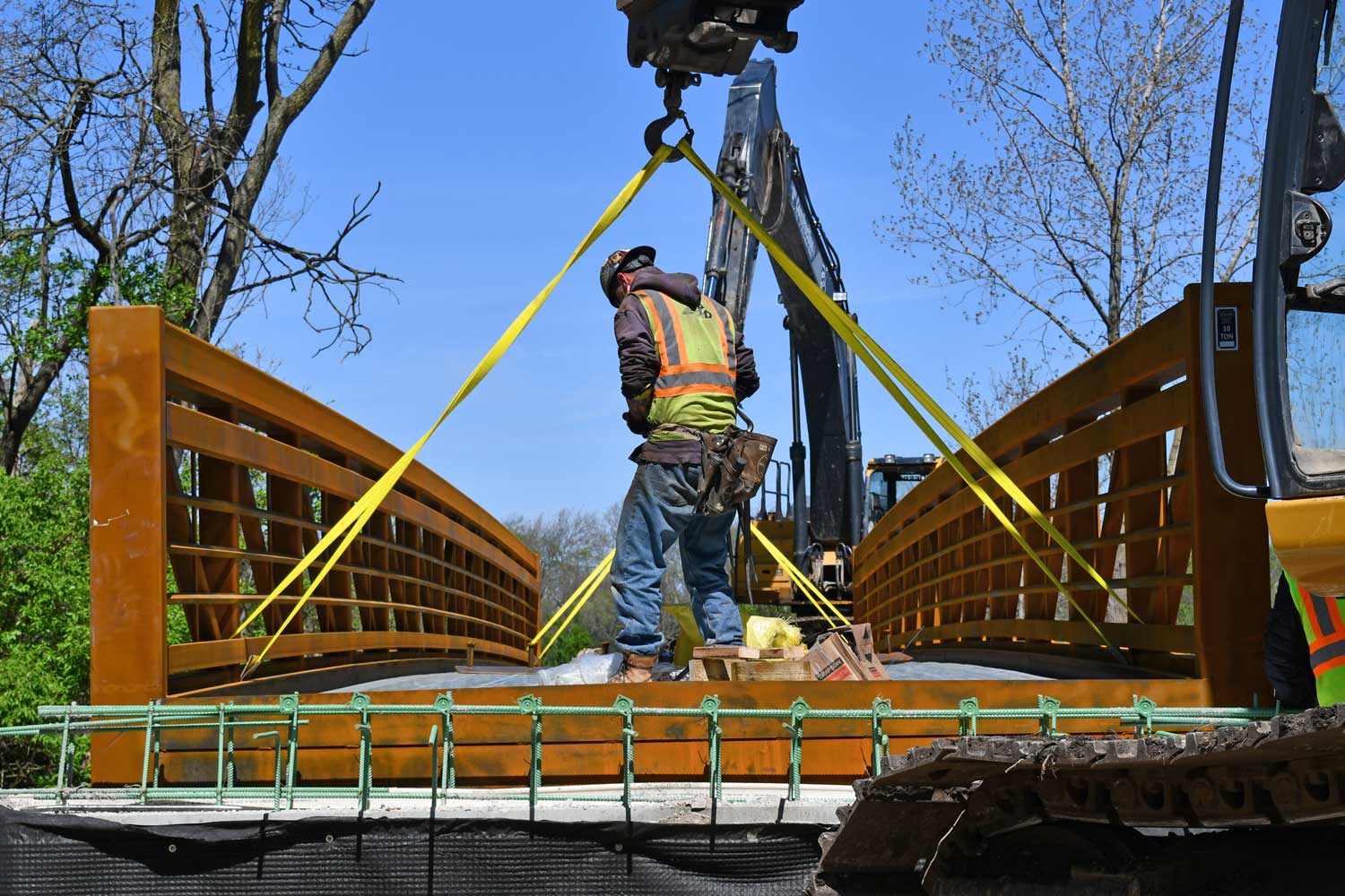 Construction worker standing on bridge.