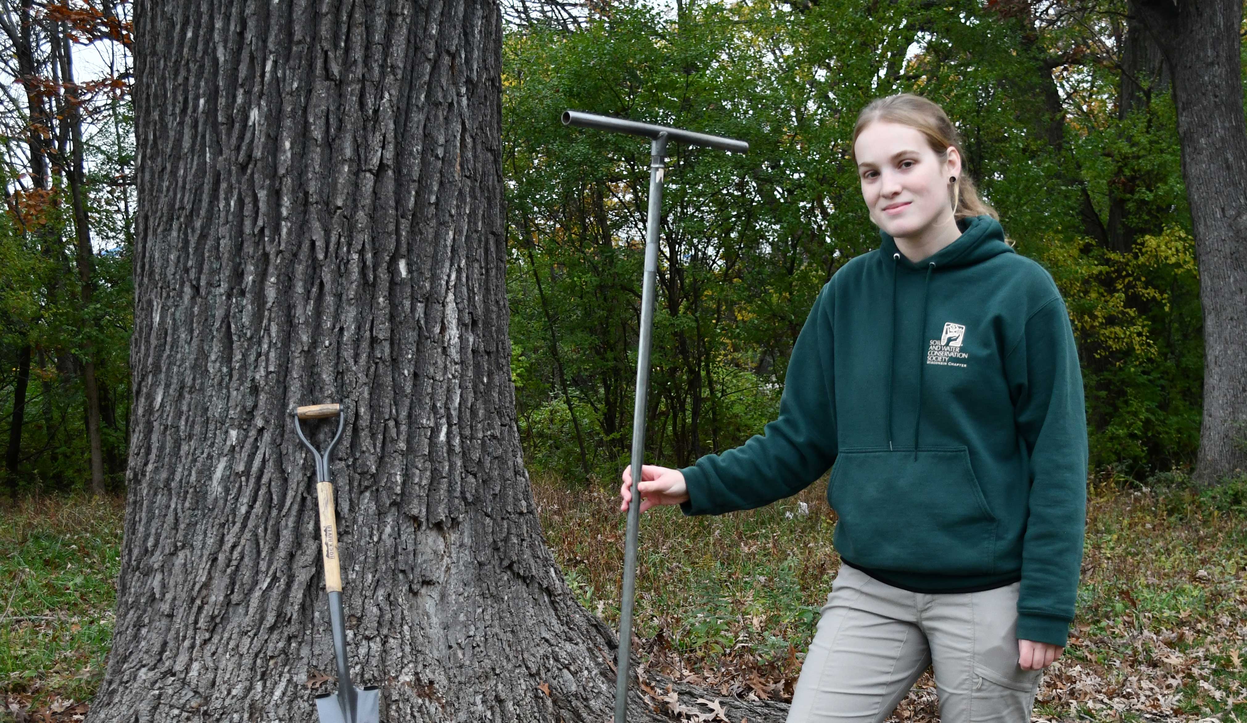 Roz Remsen standing in front of a white oak tree.