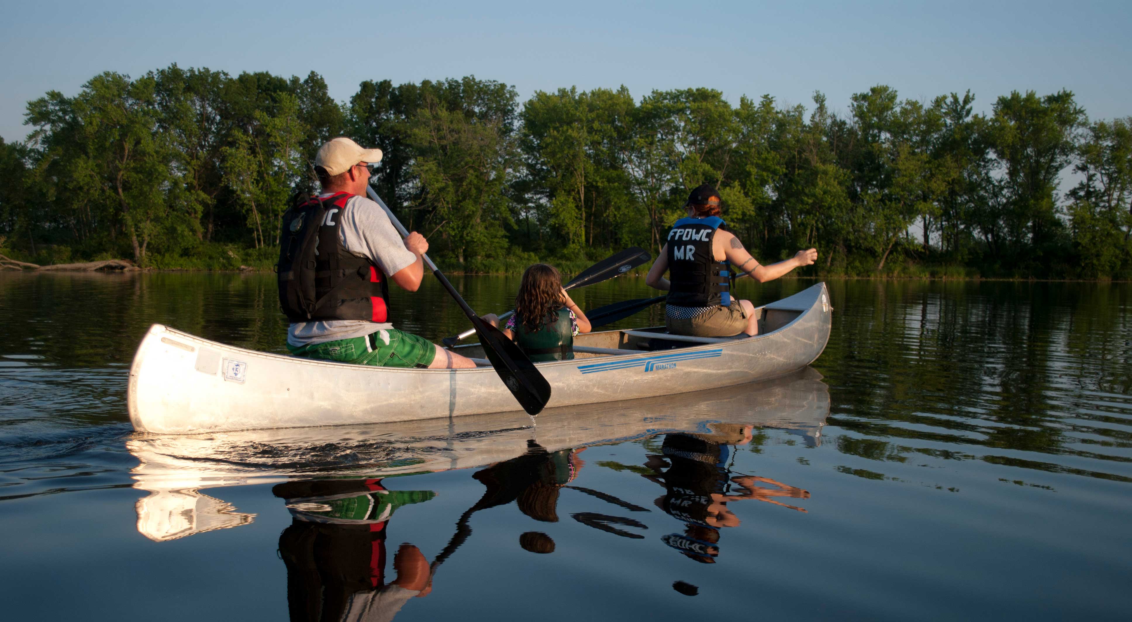 Three people in a canoe.