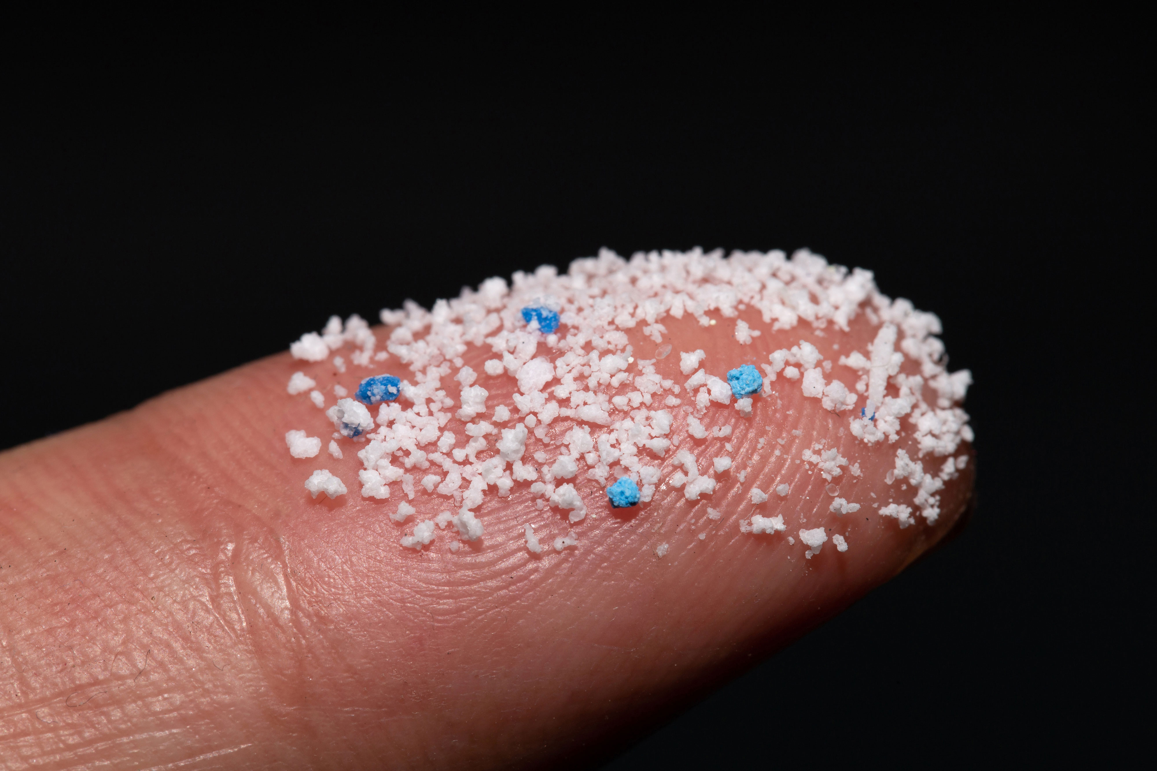 Small plastic pellets on the finger.