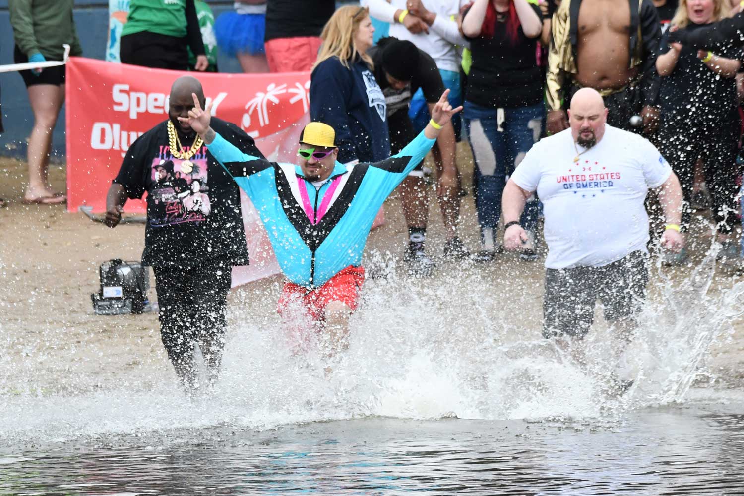 People splash into the water during the Polar Plunge.
