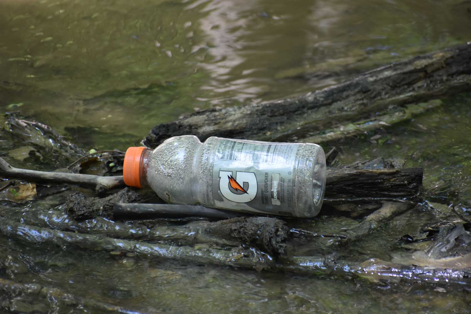 An old Gatorade bottle floating in the water.