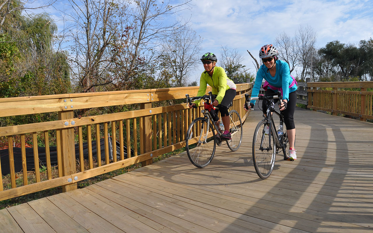 Two bicyclists along the DuPage River Trail.