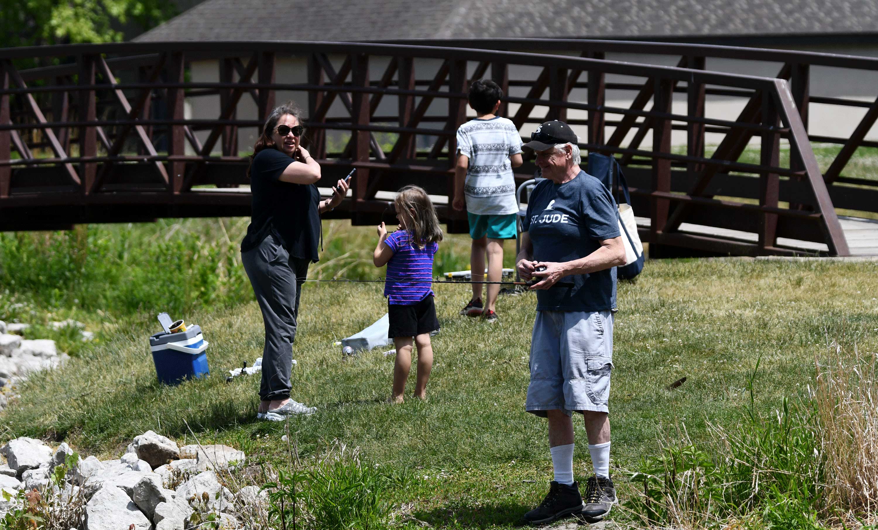 People fishing by bridge at Isle a la Cache.