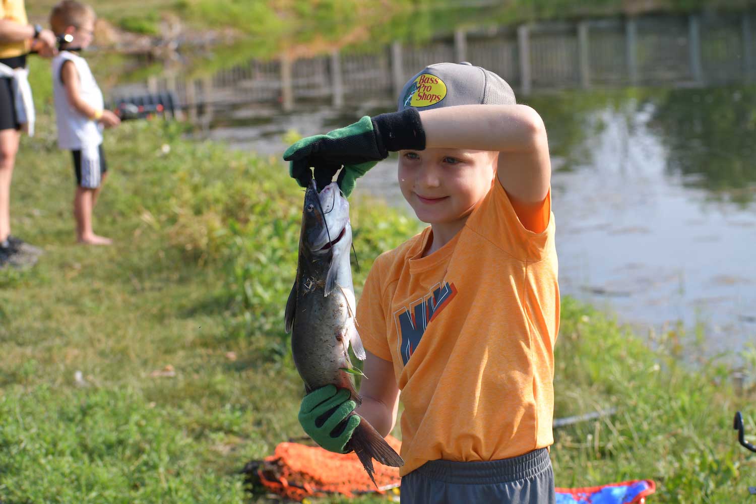 A child holding a fish they caught.