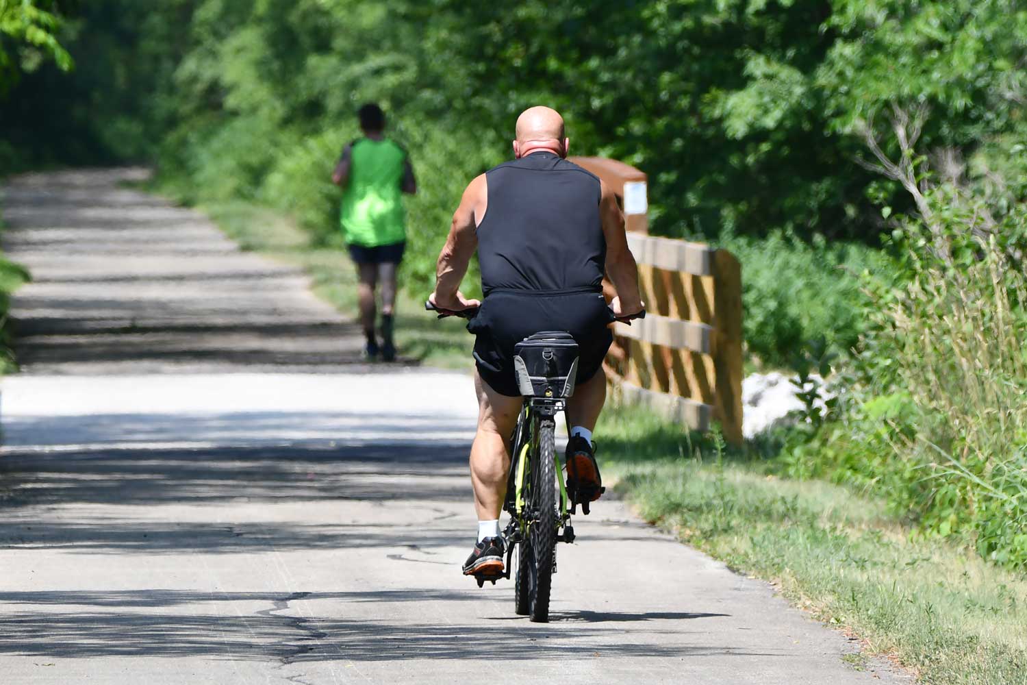 Person riding bike on a paved trail.
