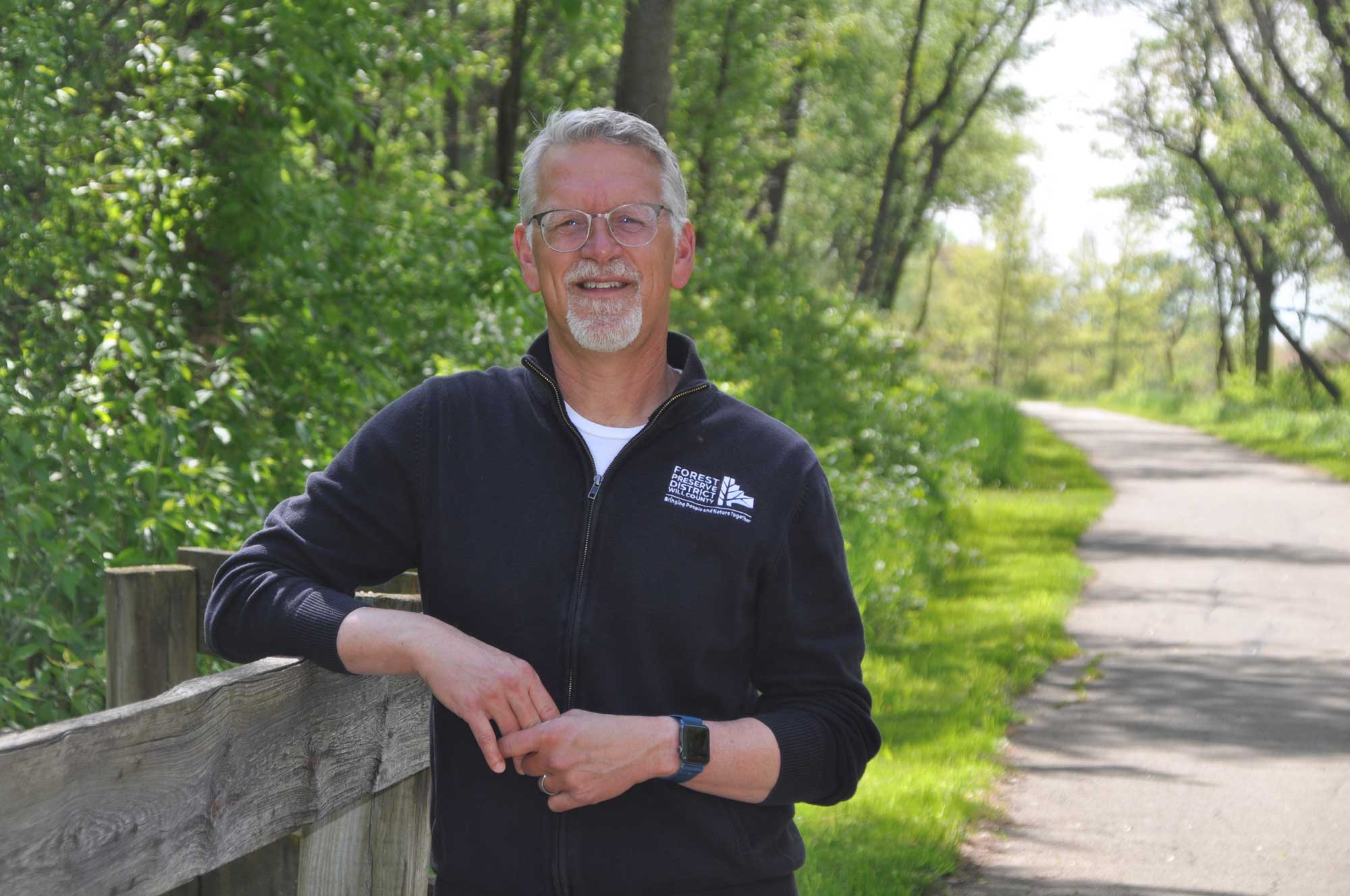 A man stands on a trail.