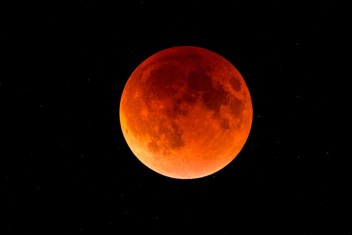 A reddish colored moon during a lunar eclipse.