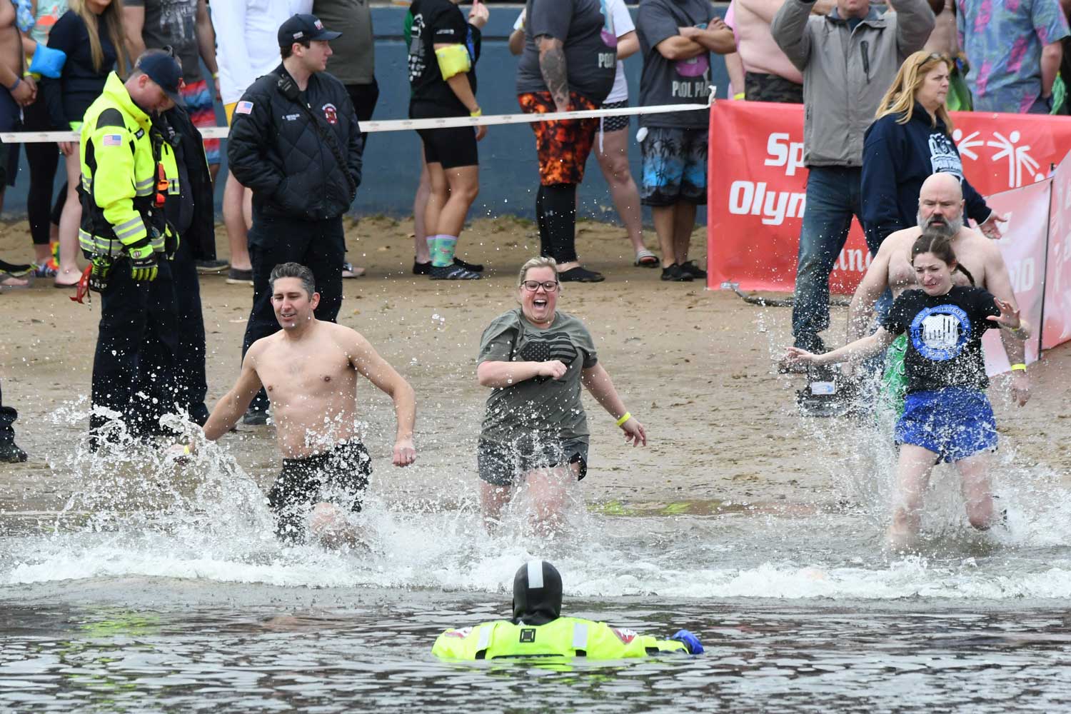 People splash into the water during the Polar Plunge