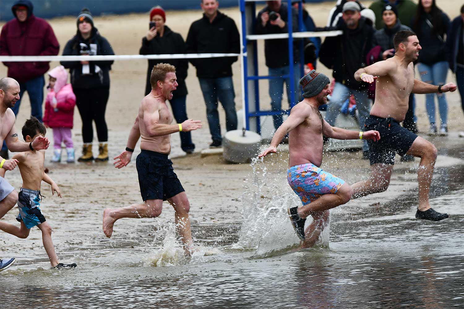People splash into the water during the Polar Plunge.