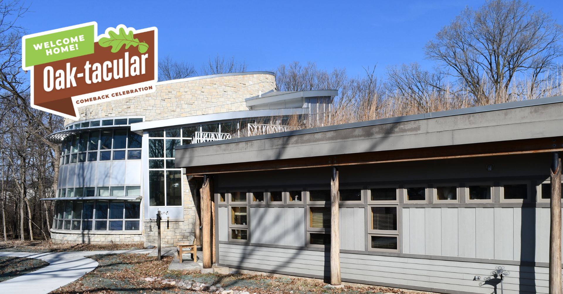 A wooden and metal sign for Hidden Oaks Nature Center outside a building.