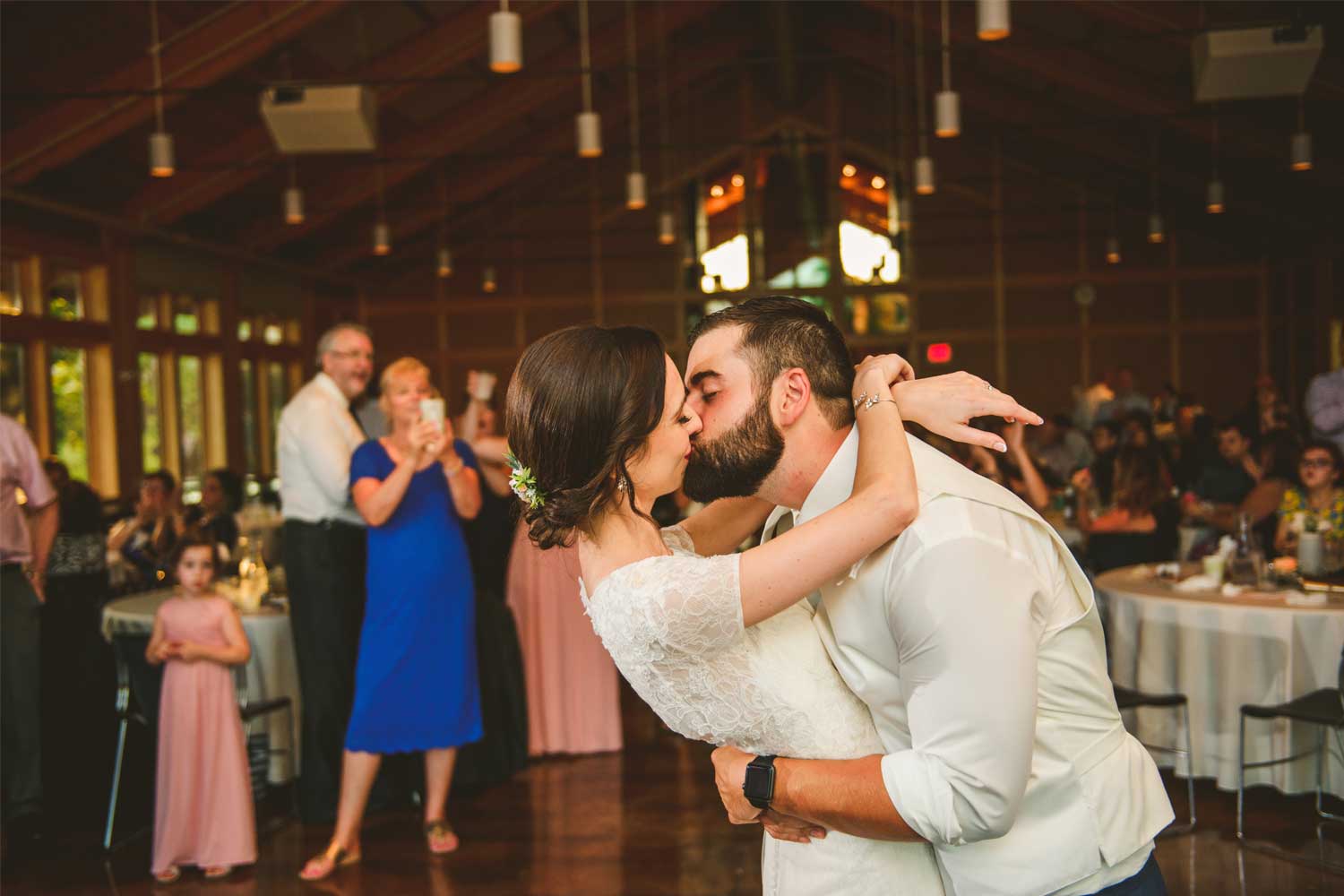 Newly married couple kissing at wedding reception