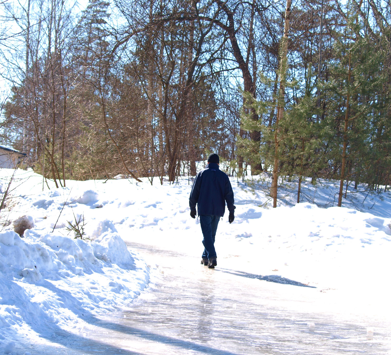 A man hiking on an ice covered path