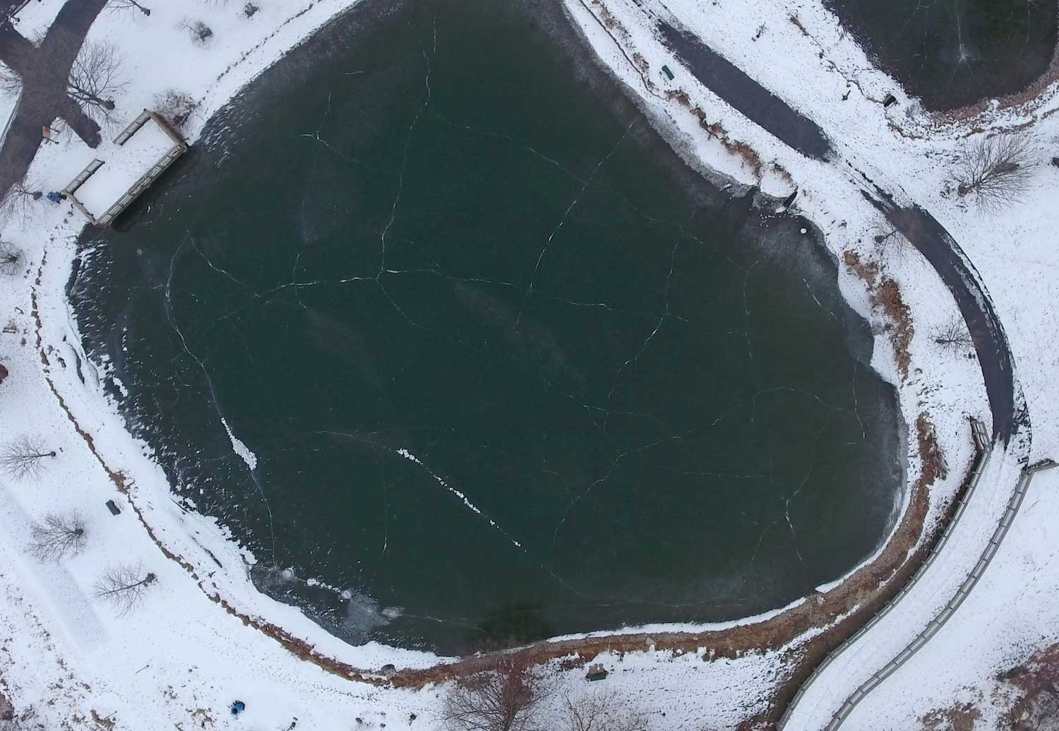An aerial view of a frozen pond.