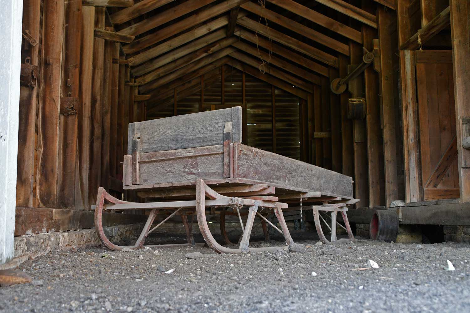 An old farm implement in a barn.