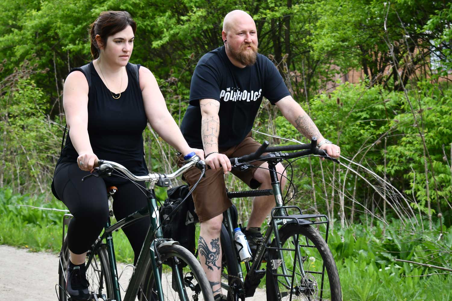 Two people biking on a trail.