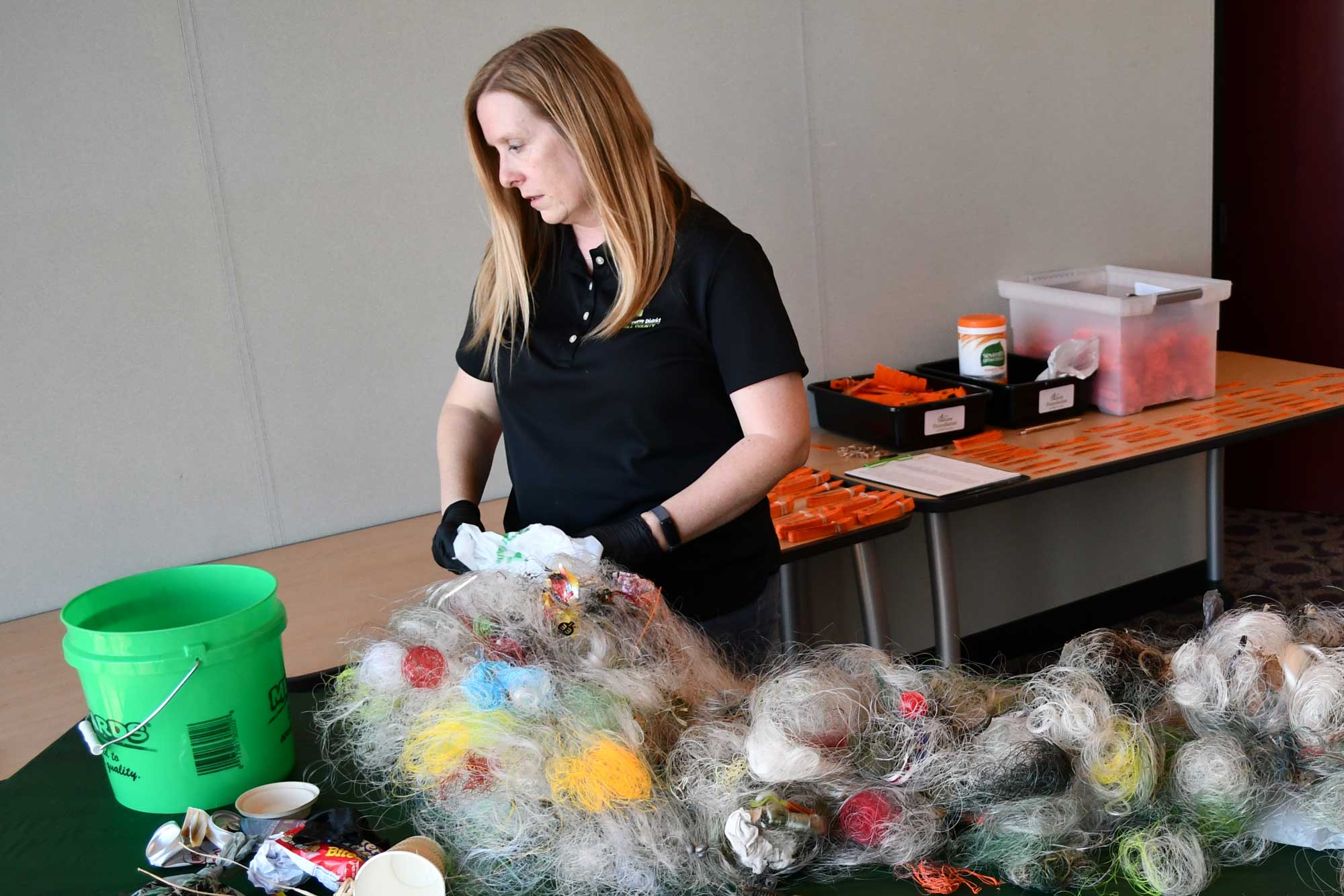 A woman sorts through fishing line that has been collected for recycling.