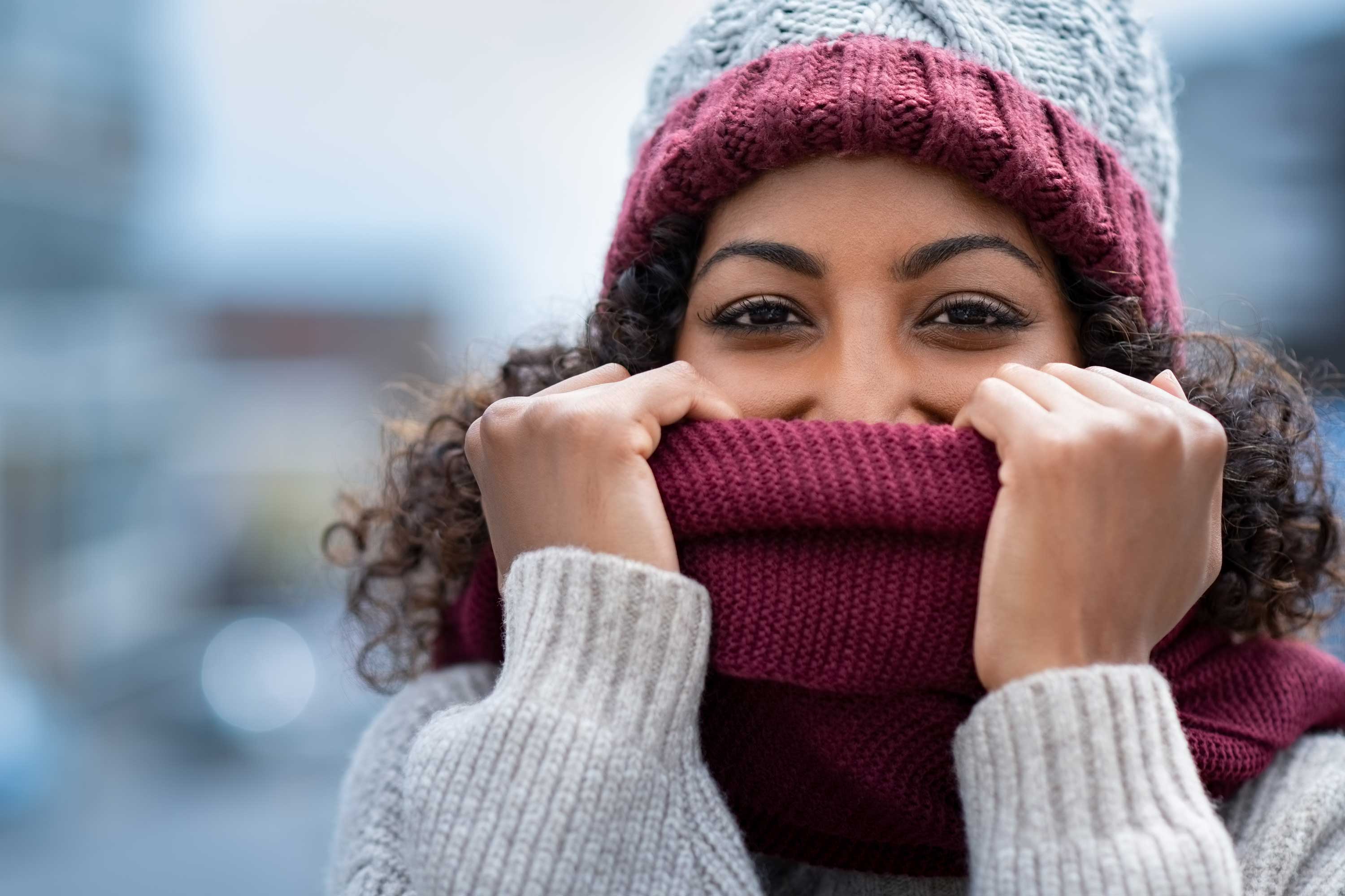 A woman wearing a hat and scarf.
