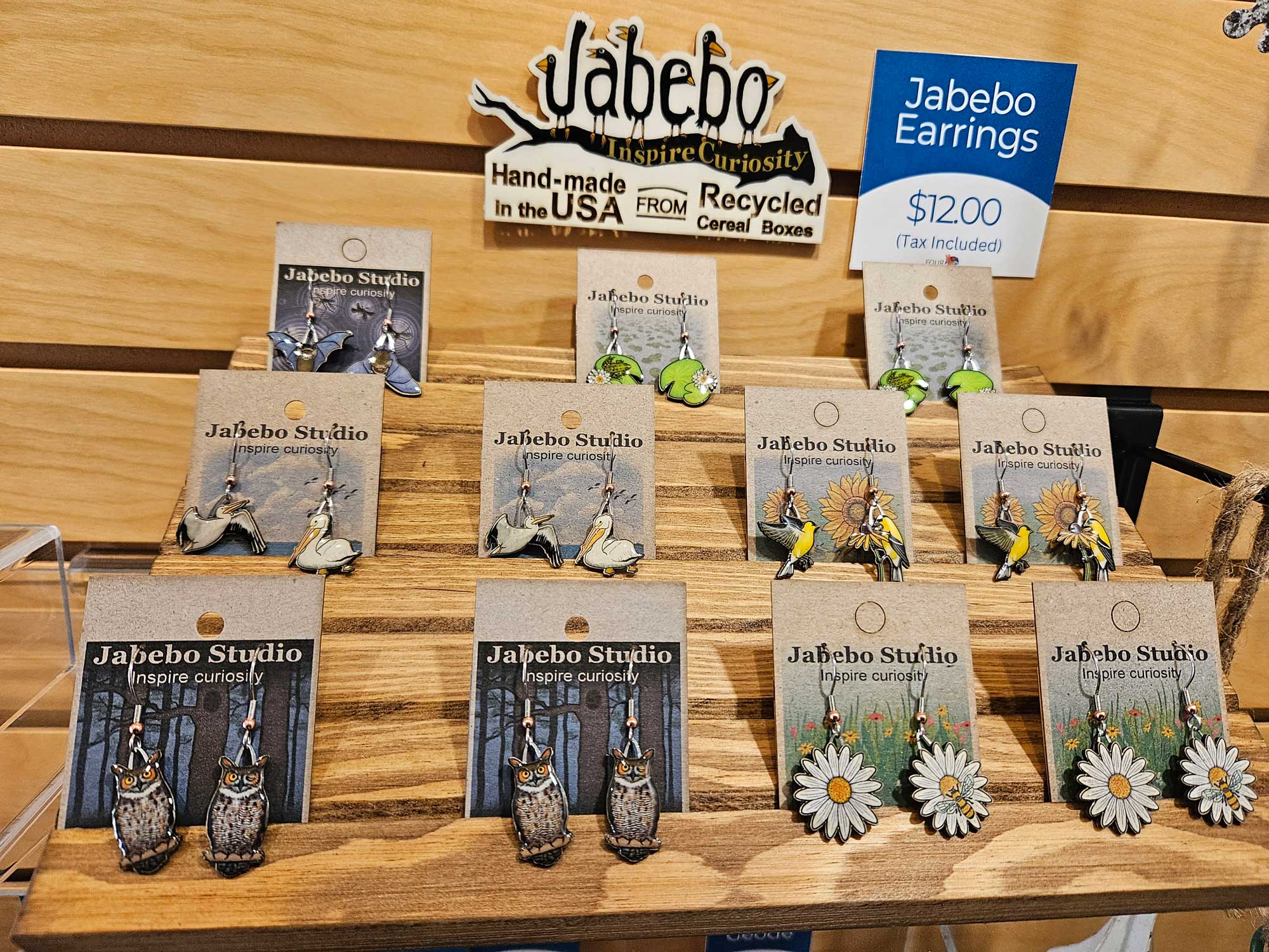 Earrings for sale hanging on a wall