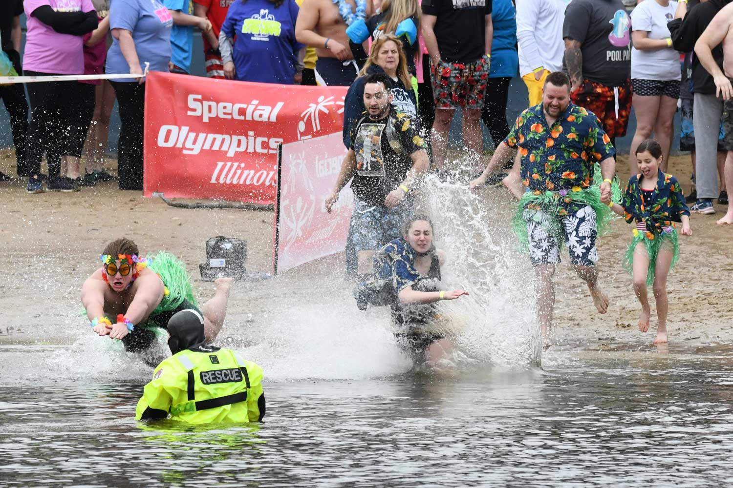 People splash into the water during the Polar Plunge.