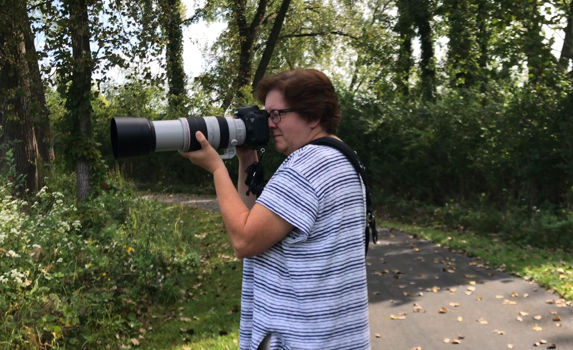 Woman on a trail with her camera