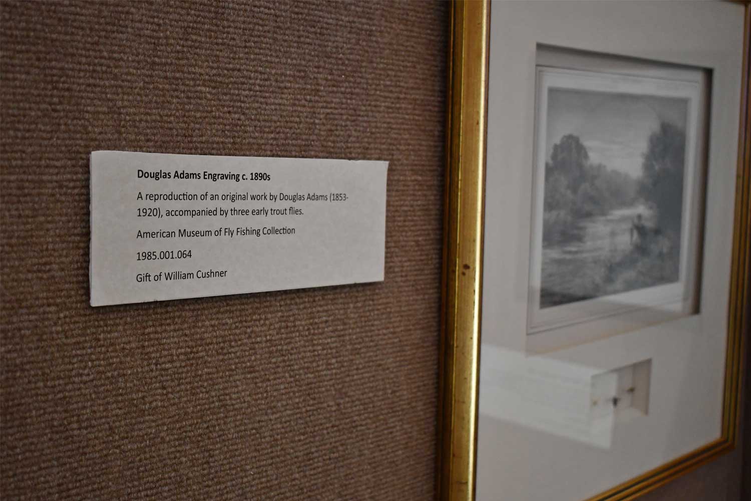 Exhibit description sign near a photo.