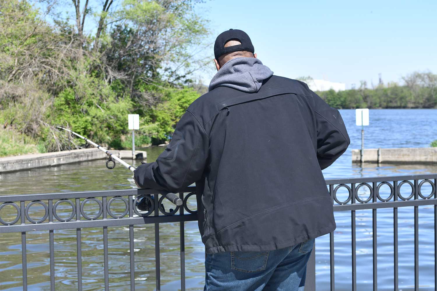 Person fishing with water in the background.