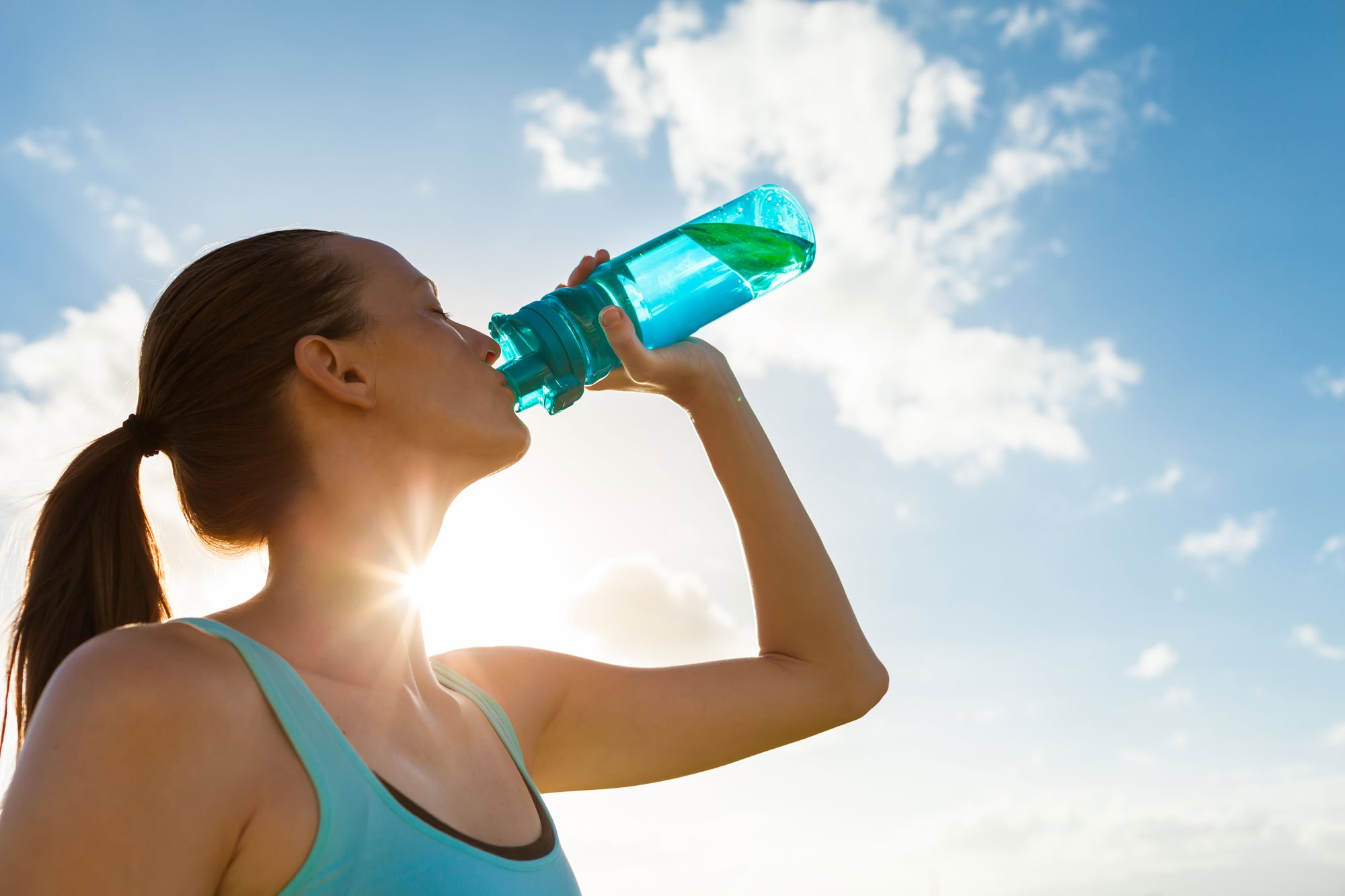 A woman drinks water.
