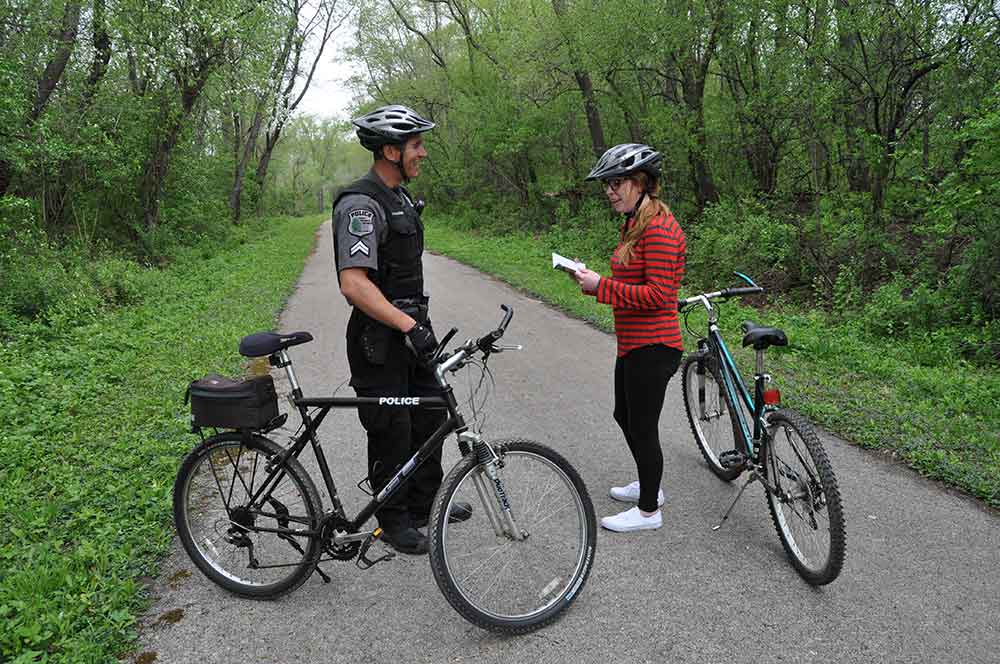 Police and cyclist on trail