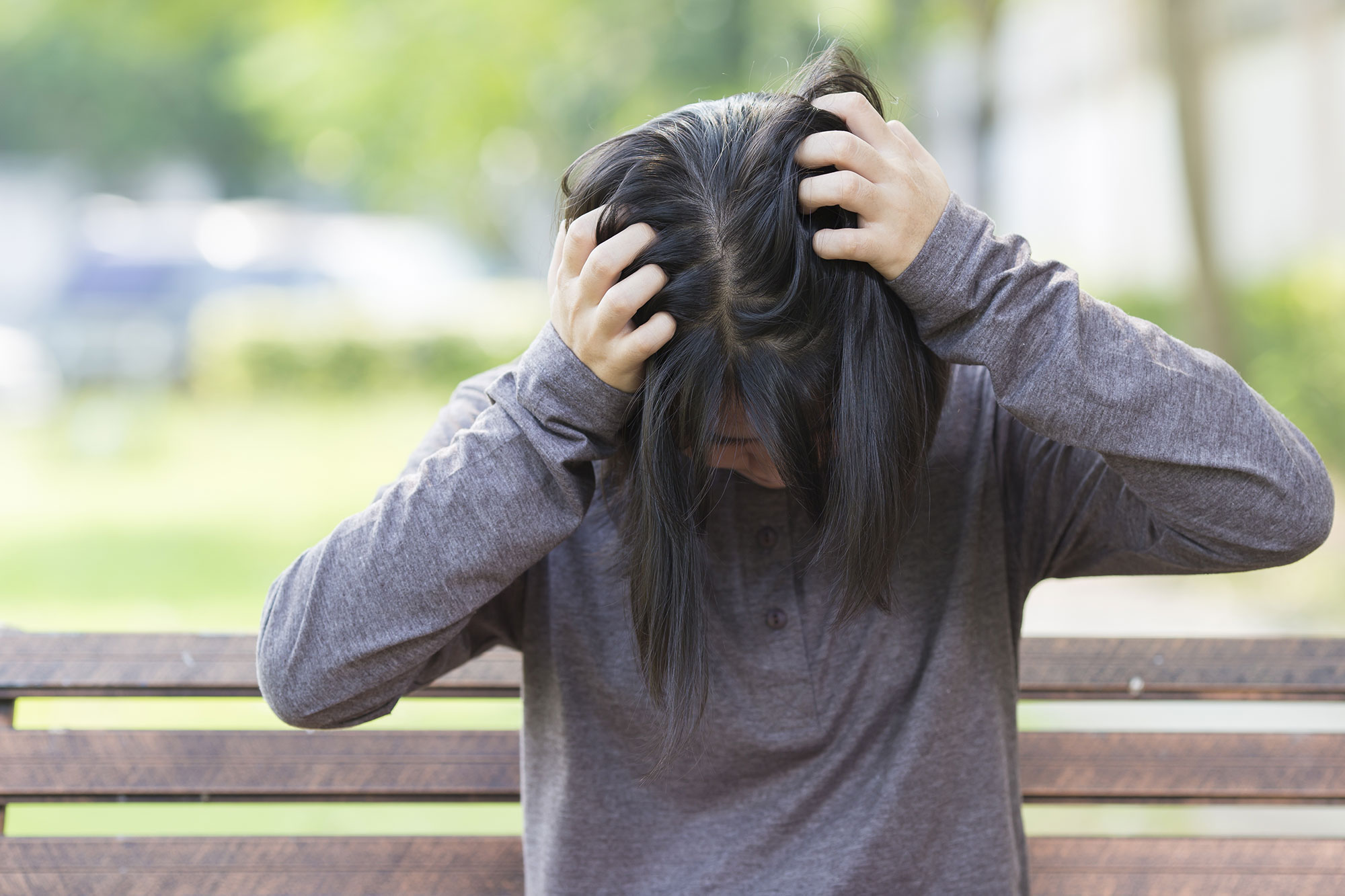 A woman holding on to her head.