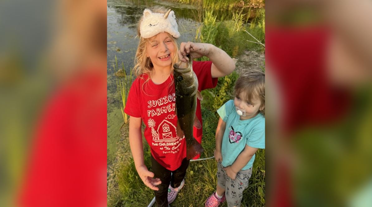 A Fish Tales Photo Contest winner holding a fish.