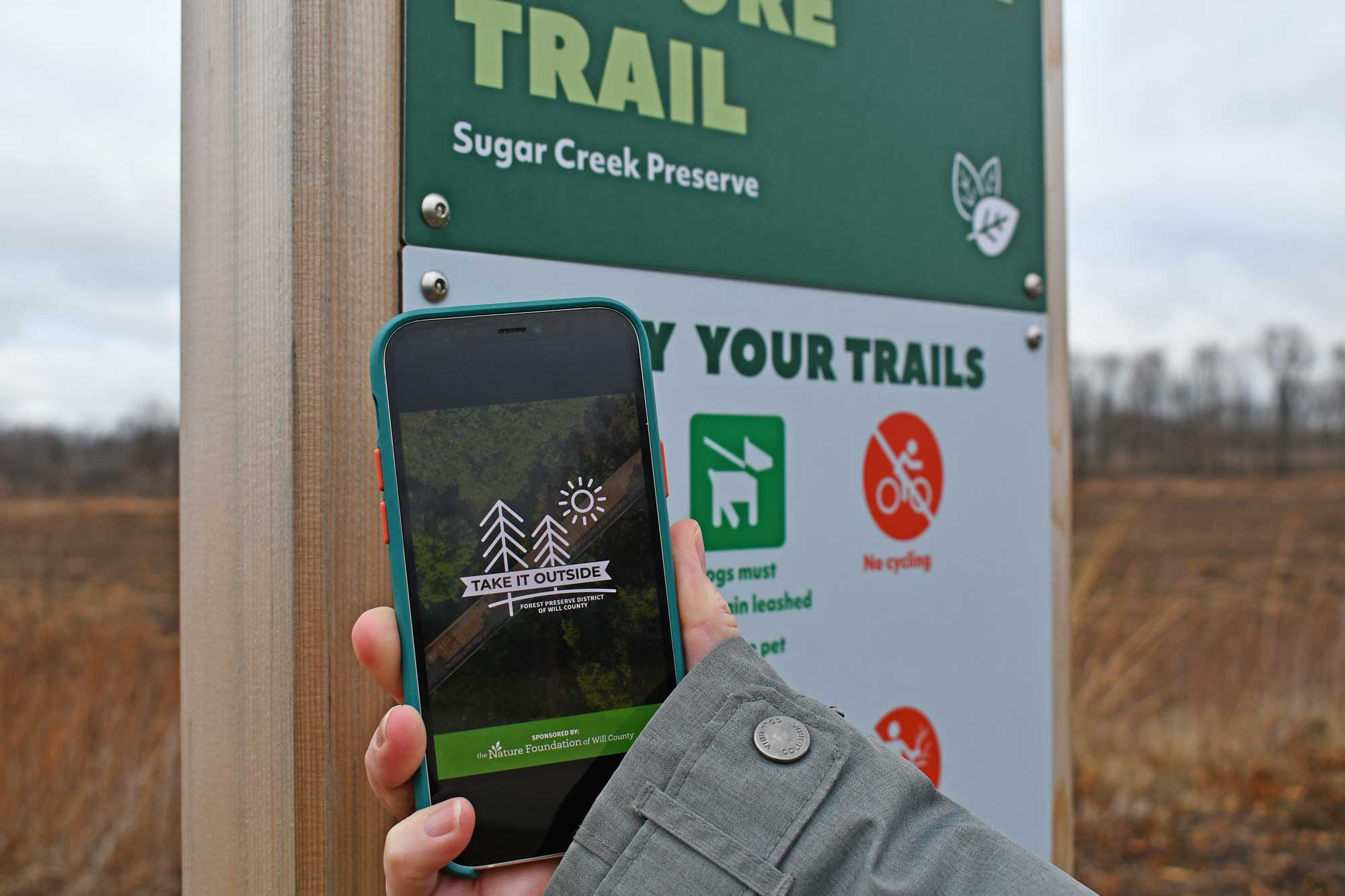 Image of phone featuring Goosechase app and sign in background