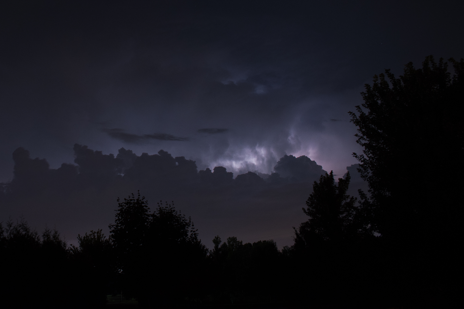 Night view with lightning in background