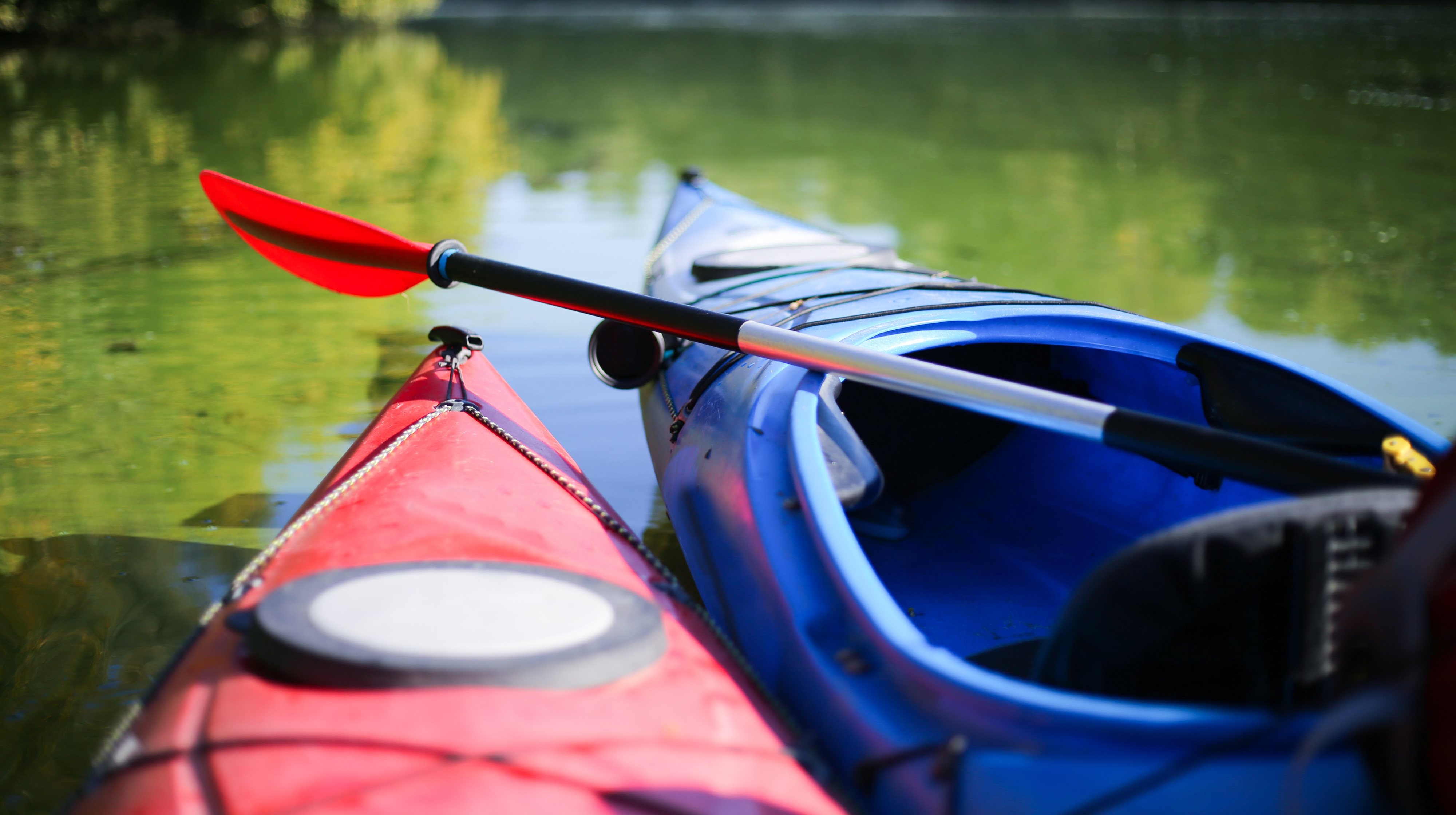 Two empty kayaks on the water.