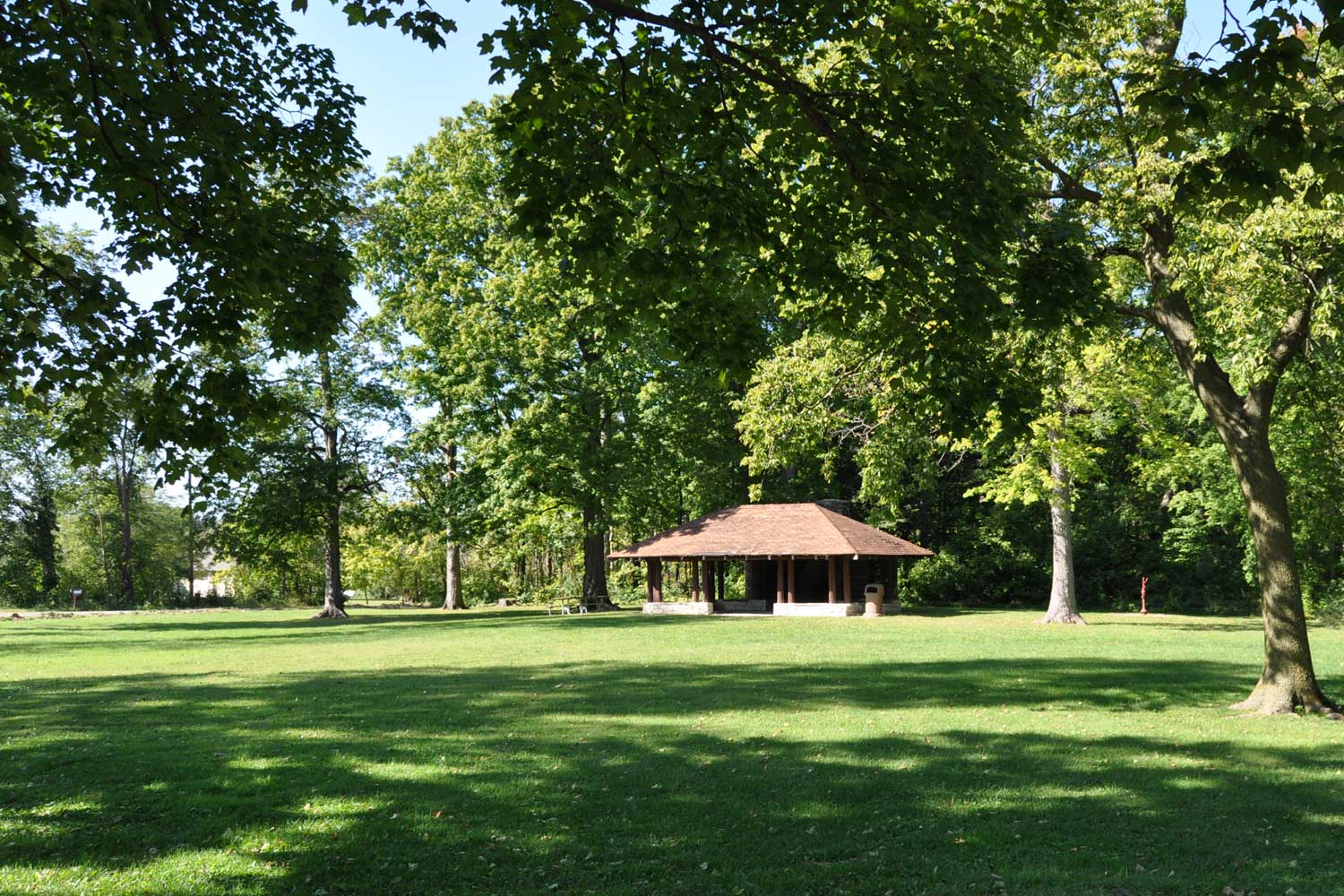 Picnic shelter surrounded by trees.