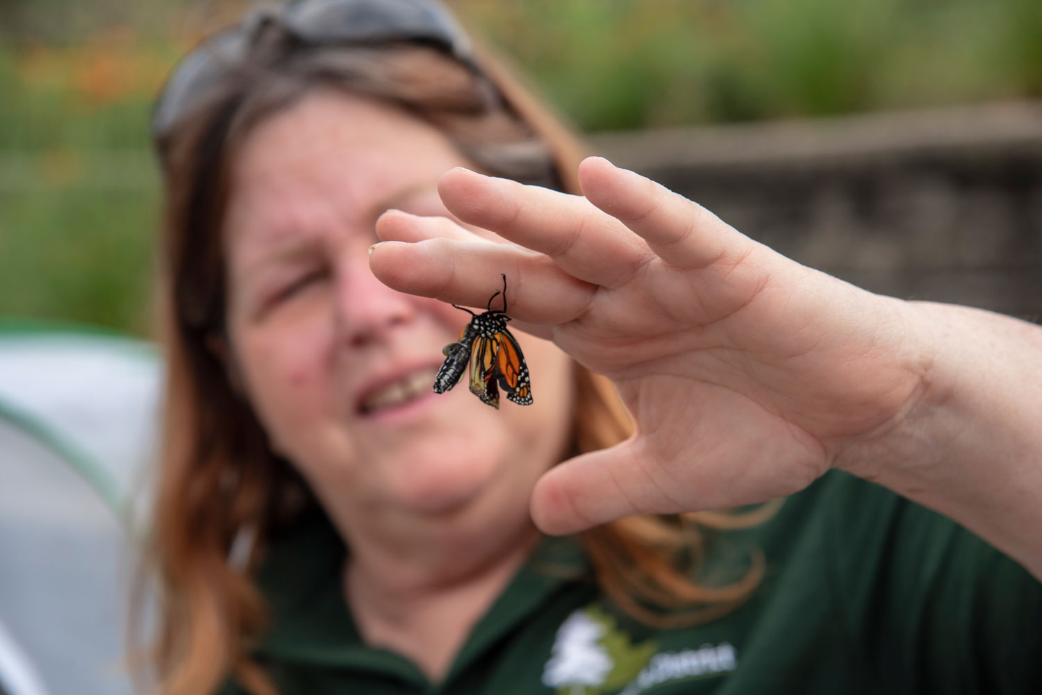 Woman holding a monarch butterfly