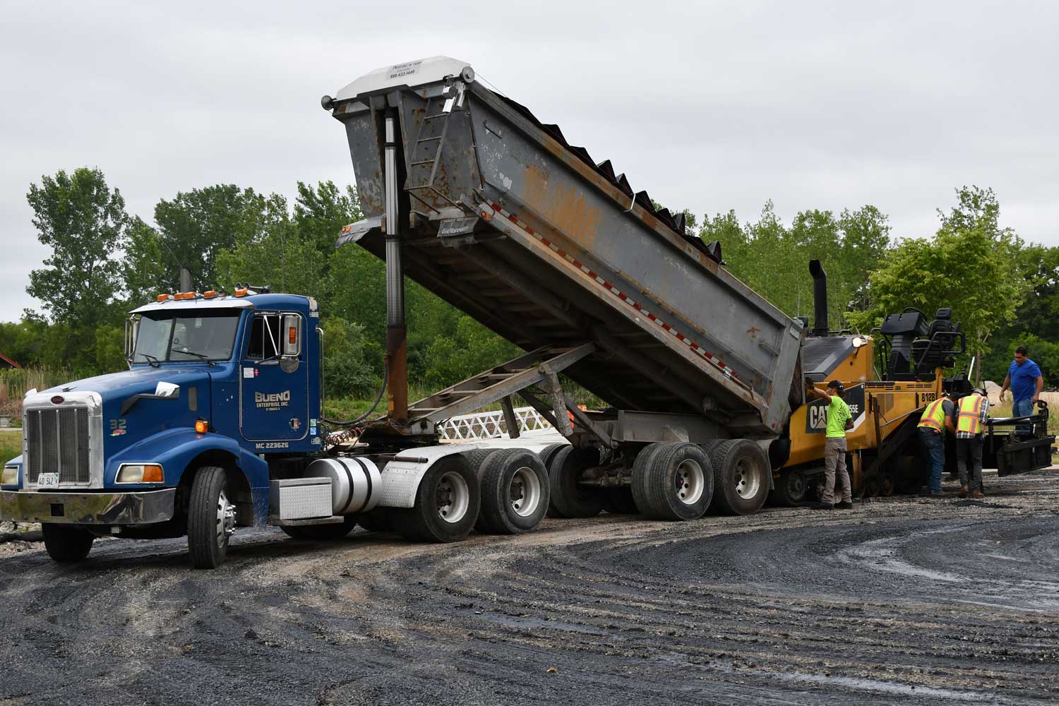 Truck dumping materials.