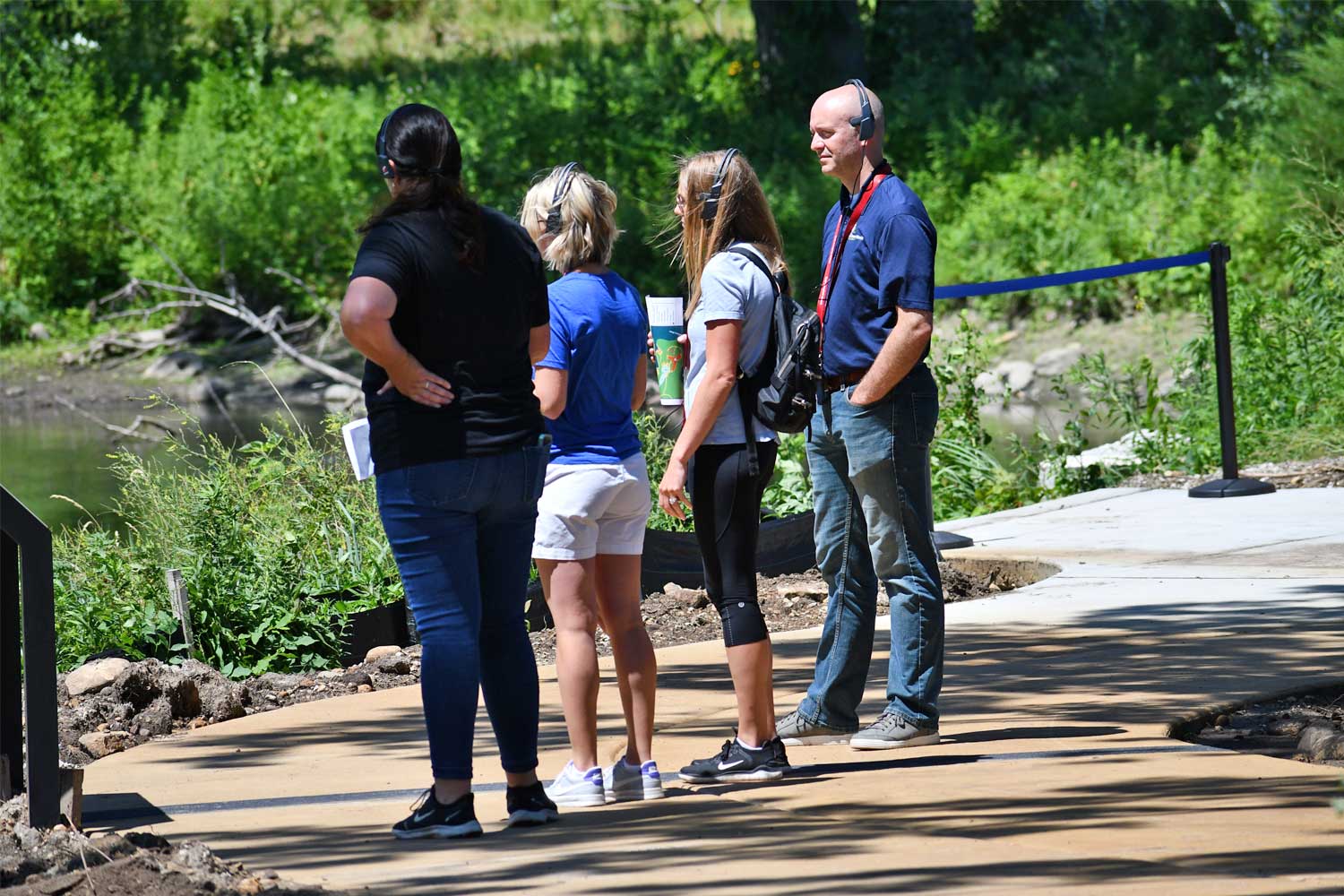 People wearing taking an audio tour along a trail