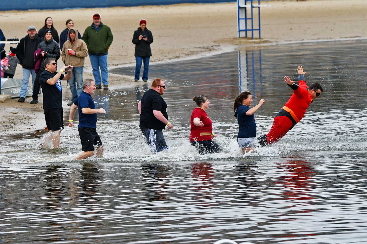 People splash into the water during the Polar Plunge.
