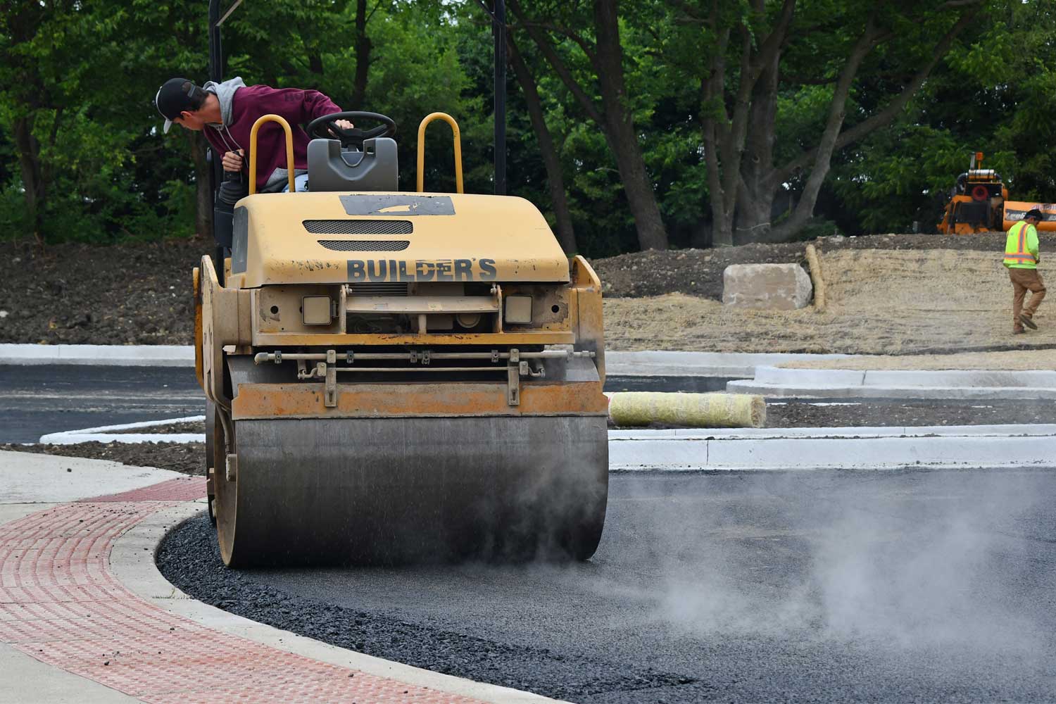 Construction vehicle paving parking lot.