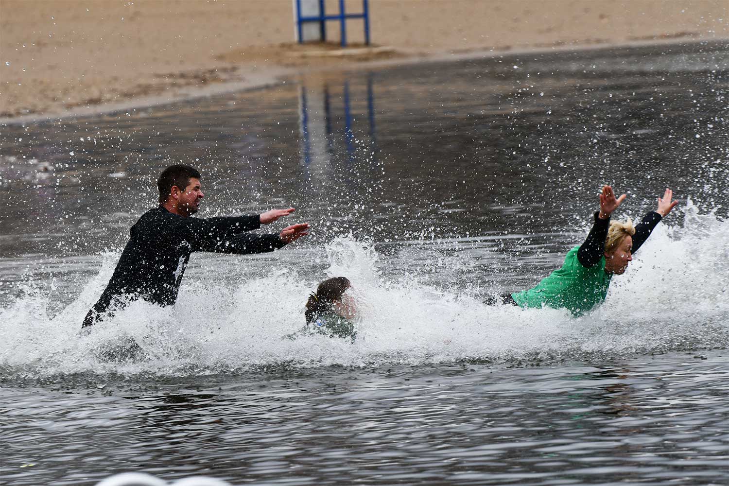 People splash into the water during the Polar Plunge.