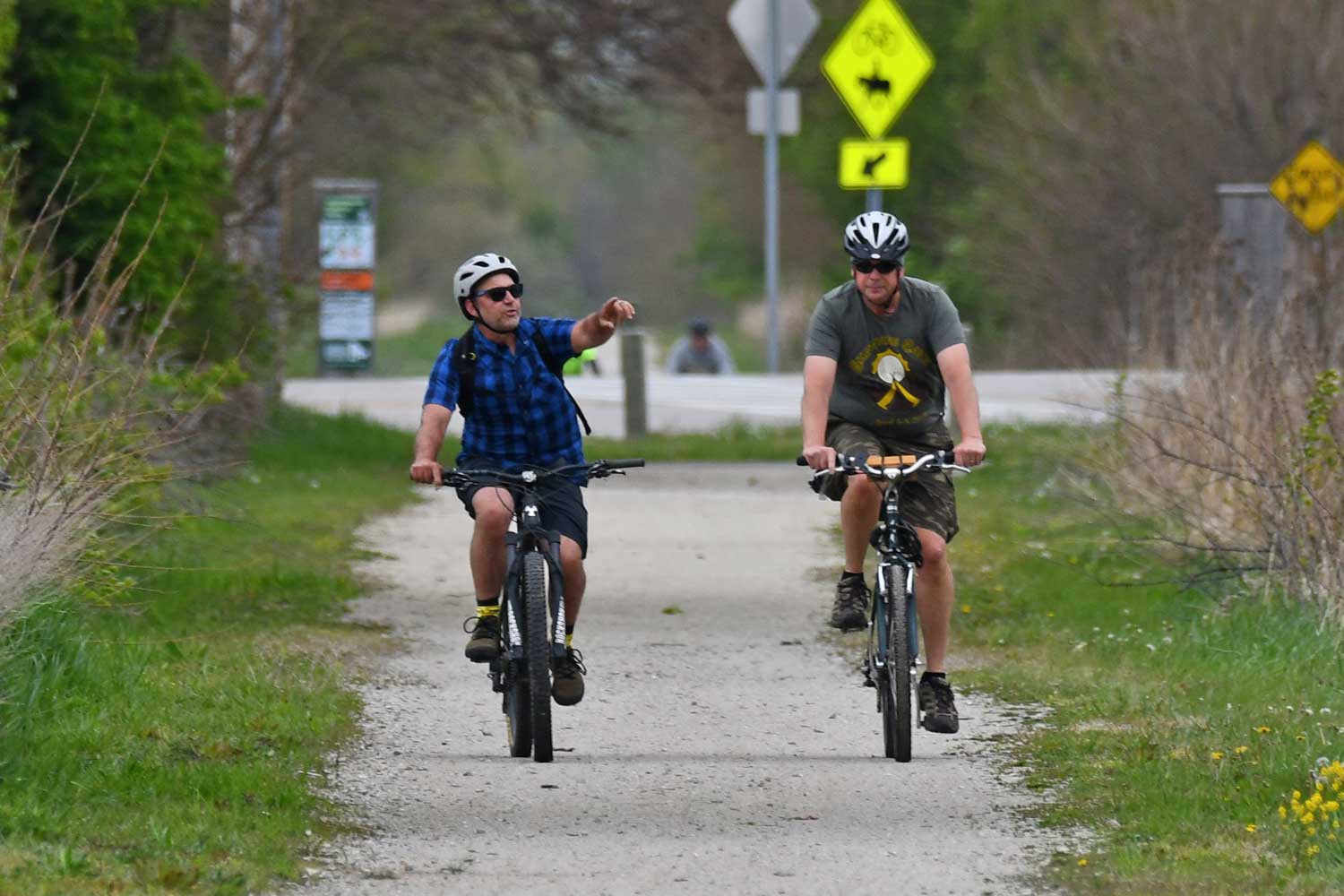 Two people biking on a trail.