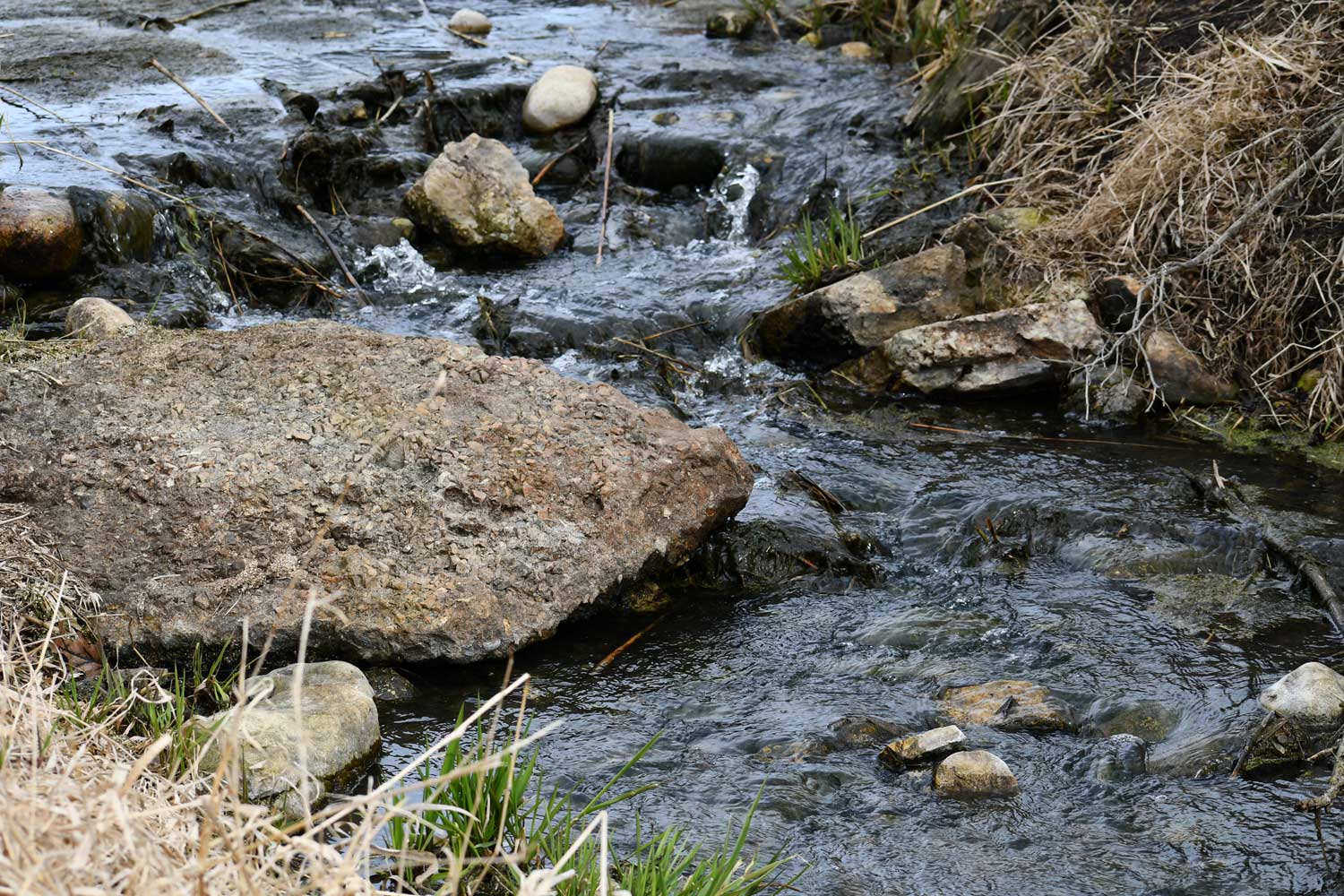 Water flowing over and around rocks.